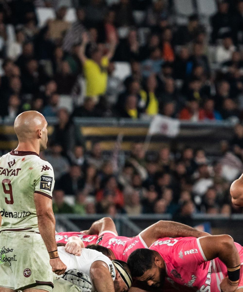 A rugby match between Stade Français and Union Bordeaux Bègles in the Top 14 league, showcasing the teams in action on the field