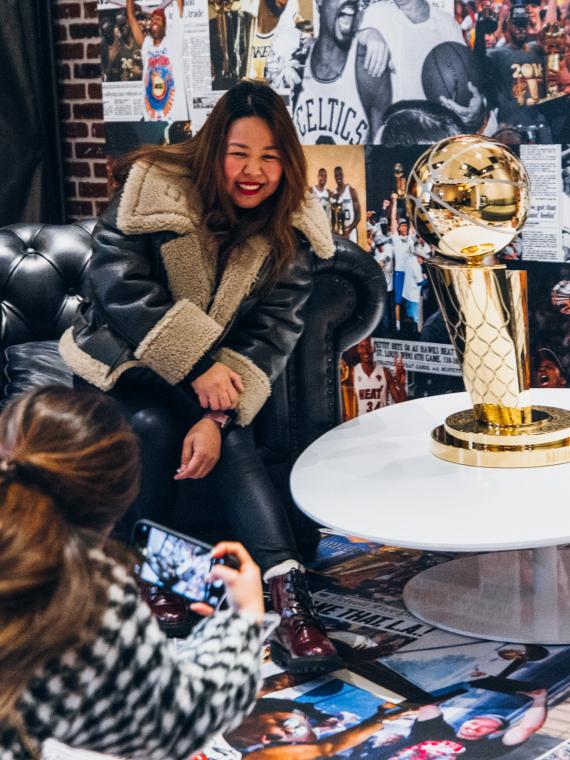 Picture of a fan beside the NBA trophy