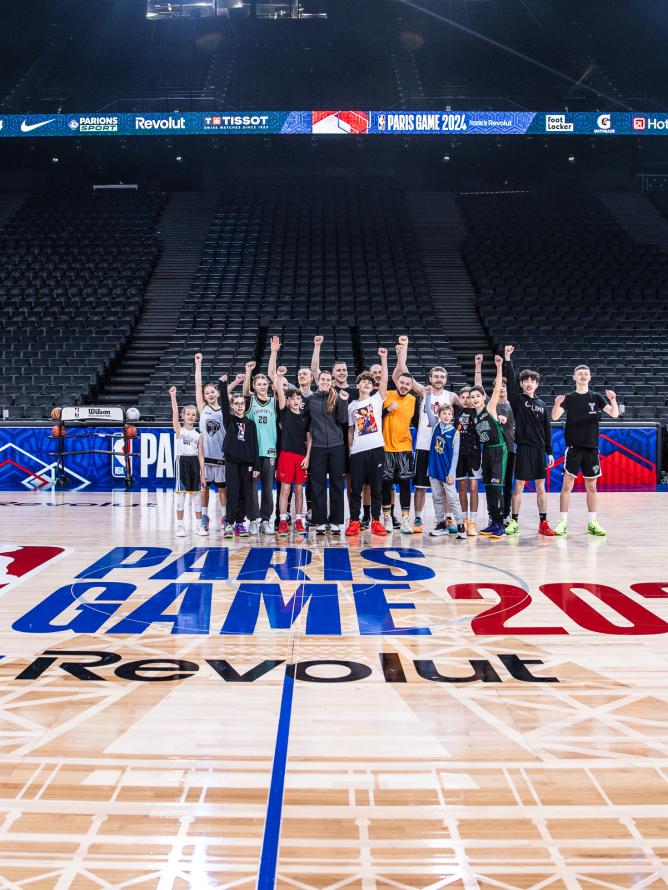 Group photoshoot on the basket ball floor before the game