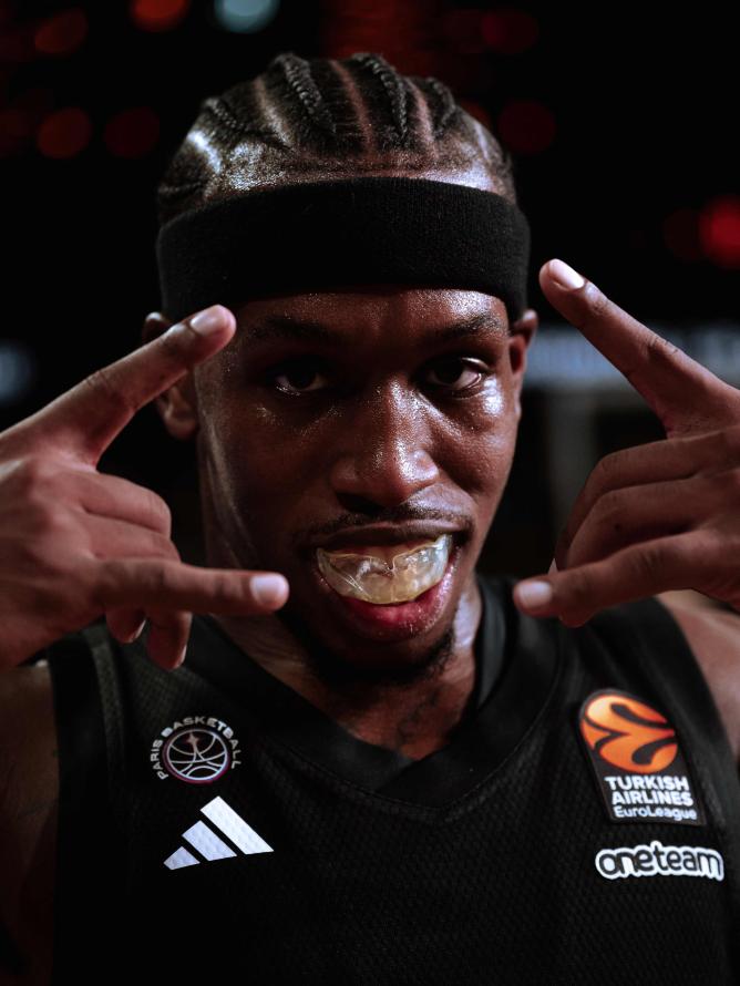 Paris Basketball player TJ Short in action at the Adidas Arena, dribbling and preparing for a play during a EuroLeague game