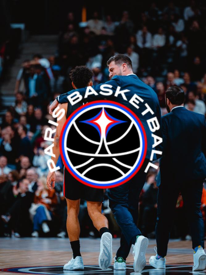 Paris Basketball players and coach Tiago Splitter strategizing on the court at the Adidas Arena during a EuroLeague game