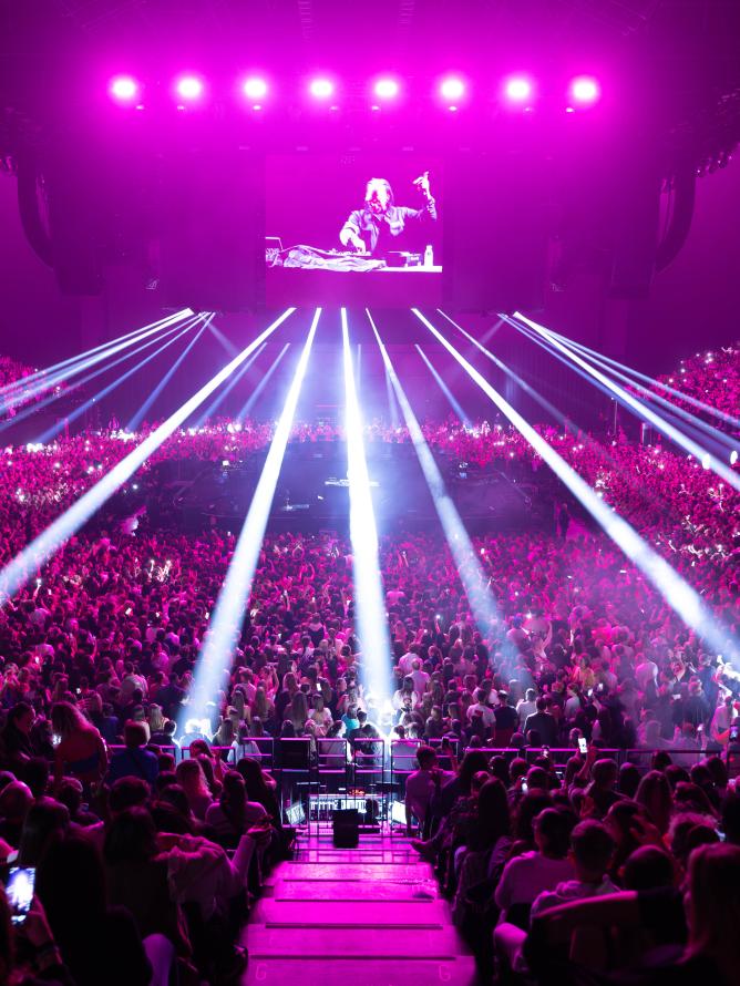 View of the audience area during the Kylie Minogue concert at the LDLC Arena, showcasing the vibrant atmosphere and stage visibility from the public seating