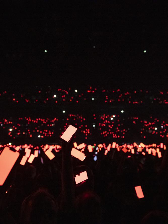 Close-up view from the audience near the stage during a performance, capturing the singer in action with an intimate, immersive experience